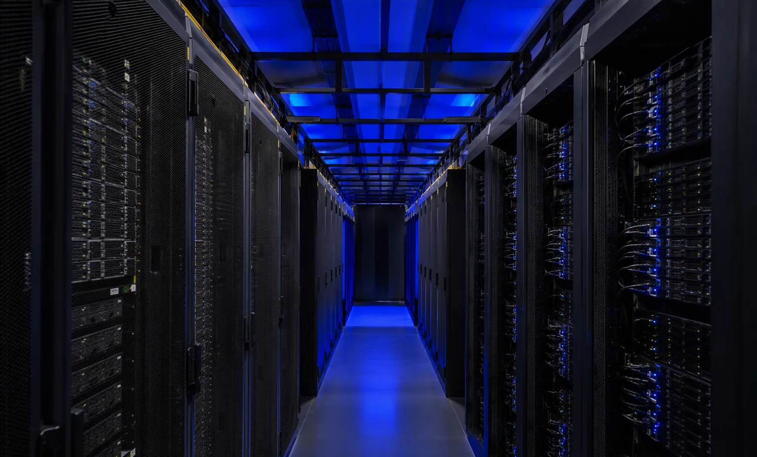 Photorealistic photograph of a data center cold aisle with storage racks and cable management, blue ambient lighting, dark tones.