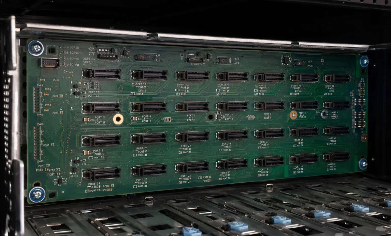 24-bay 2.5 inch SAS expander backplane board inside a server chassis, dark interior.