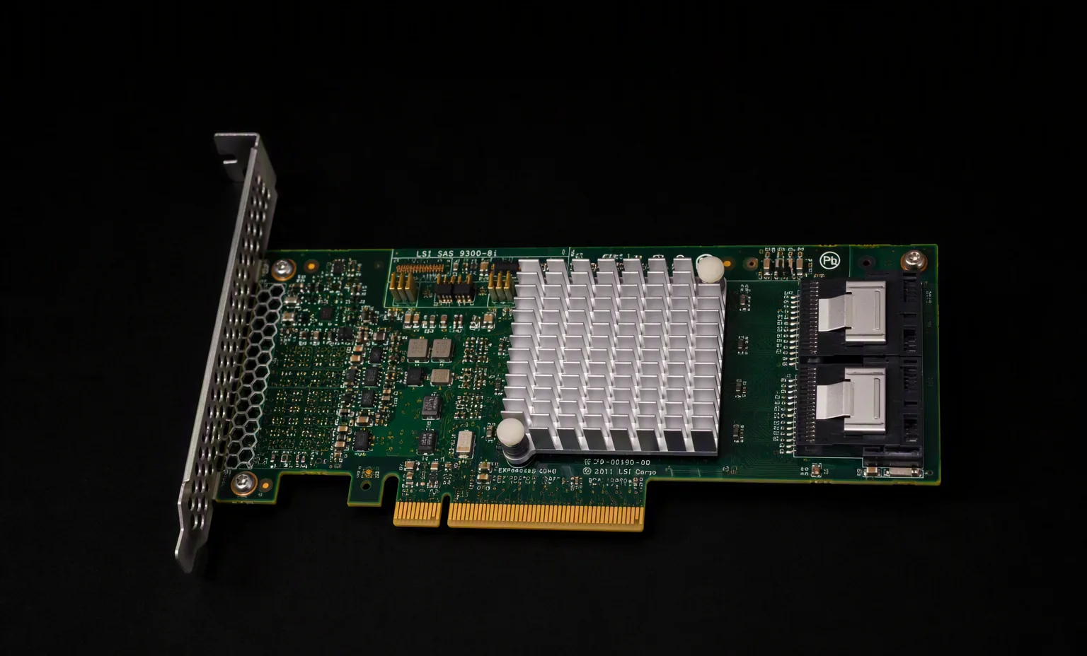 LSI 9300-8i 12Gb SAS HBA PCIe card, green PCB with heatsink and SFF-8643 ports, dark studio.