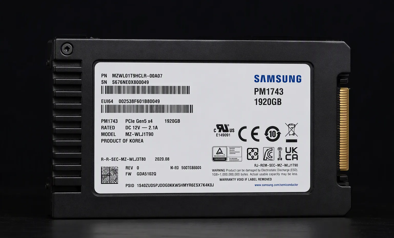 Samsung PM1743 PCIe Gen5 enterprise E3.S NVMe SSD, slim form factor label view, dark studio.