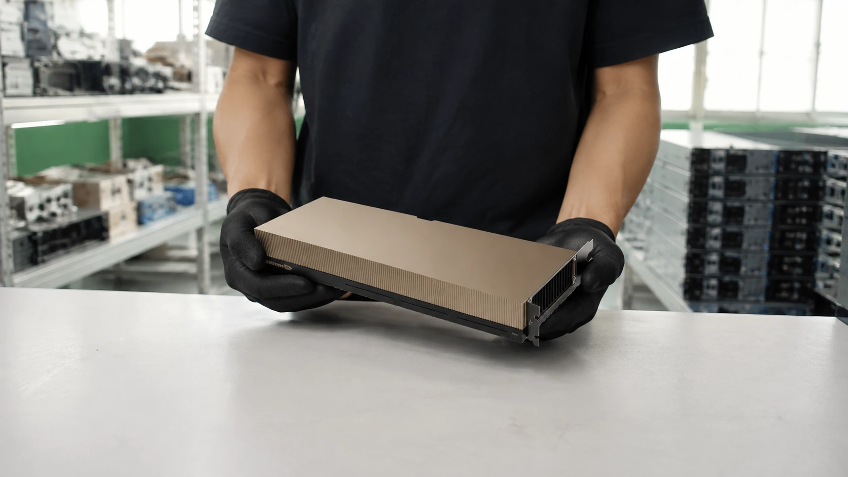 Illustrative presentation of one NVIDIA H100 PCIe accelerator supported in two black-gloved hands above a warehouse workbench