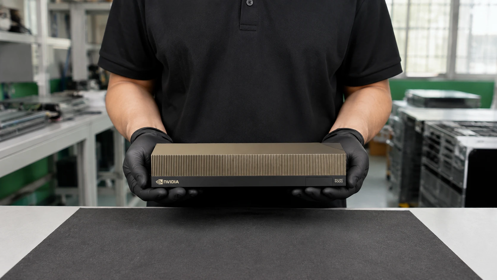 Illustrative presentation of one RTX PRO 6000 Blackwell Server Edition air-cooled card held in two black-gloved hands